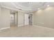 Spacious bedroom with tile floors that leads to an ensuite bathroom, and a view to another bedroom at 3314 Wood Thrush Dr # 124, Punta Gorda, FL 33950
