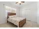 Bright bedroom featuring a bed with patterned linens, white trim, and closet doors at 3314 Wood Thrush Dr # 124, Punta Gorda, FL 33950