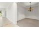 Neutral dining area with carpeting and chandelier at 3314 Wood Thrush Dr # 124, Punta Gorda, FL 33950