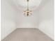 An empty dining room with neutral carpeting, a ceiling fan and bright white walls at 3314 Wood Thrush Dr # 124, Punta Gorda, FL 33950