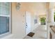 Welcoming condo entrance featuring unit 124, a 'Welcome' doormat, and an exterior light fixture at 3314 Wood Thrush Dr # 124, Punta Gorda, FL 33950