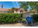 Little Harbor condos with landscaping and an American flag under a clear blue sky at 3314 Wood Thrush Dr # 124, Punta Gorda, FL 33950