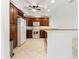 Well-equipped kitchen with wood cabinets, white appliances, and a breakfast bar area at 3314 Wood Thrush Dr # 124, Punta Gorda, FL 33950