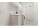 Bright laundry room with white cabinets, a sink, and a modern washing machine at 3314 Wood Thrush Dr # 124, Punta Gorda, FL 33950