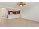 Open-concept living space with tile flooring, leading to a modern kitchen with stainless steel appliances at 3314 Wood Thrush Dr # 124, Punta Gorda, FL 33950