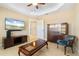 Neutral-toned living room featuring tile flooring, a ceiling fan, and wall-mounted television at 3314 Wood Thrush Dr # 124, Punta Gorda, FL 33950