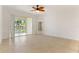 Bright, open living area with tile floors and sliding glass doors leading to a balcony at 3314 Wood Thrush Dr # 124, Punta Gorda, FL 33950