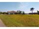 Expansive lawn in backyard overlooks waterfront canal and lush greenery at 3518 Terin Ct, Punta Gorda, FL 33950
