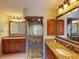 Bathroom showcases dual sinks, granite counters, and a luxurious tiled shower with glass enclosure at 3518 Terin Ct, Punta Gorda, FL 33950
