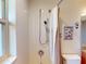 Shower stall featuring a shower-head, grab bar, and tiled walls for easy maintenance at 3518 Terin Ct, Punta Gorda, FL 33950