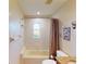 Well-lit bathroom with a shower-tub combination, and neutral wall color at 3518 Terin Ct, Punta Gorda, FL 33950