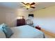 A cozy bedroom features a ceiling fan, a TV, and a dresser for organized storage at 3518 Terin Ct, Punta Gorda, FL 33950