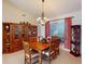 Formal dining area with a large chandelier and wooden hutch for storage at 3518 Terin Ct, Punta Gorda, FL 33950