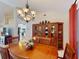 Formal dining room showcasing a large wooden hutch and chandelier lighting at 3518 Terin Ct, Punta Gorda, FL 33950