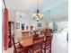 Formal dining room opening to living area with chandelier at 3518 Terin Ct, Punta Gorda, FL 33950