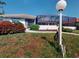 Well-manicured lawn and landscaping in the front yard complements the screened-in lanai and tile roof at 3518 Terin Ct, Punta Gorda, FL 33950