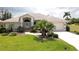 Charming single-story home featuring a well-manicured lawn, lush landscaping, and a neutral-colored tile roof at 3518 Terin Ct, Punta Gorda, FL 33950