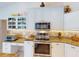 Bright kitchen with white cabinets, granite countertops, and stainless steel appliances, creating a modern space at 3518 Terin Ct, Punta Gorda, FL 33950
