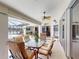 Outdoor lanai features a glass table with seating for six and a ceiling fan for added comfort at 3518 Terin Ct, Punta Gorda, FL 33950
