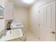 The laundry room includes a utility sink and new stainless-steel washer and dryer at 3518 Terin Ct, Punta Gorda, FL 33950