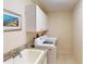Well-lit laundry room has storage cabinets, utility sink, and new washer and dryer at 3518 Terin Ct, Punta Gorda, FL 33950