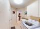 Bright laundry room with ample storage, stainless steel appliances, and tile flooring at 3518 Terin Ct, Punta Gorda, FL 33950
