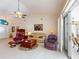 Bright living room features vaulted ceiling, tile floors, stylish furniture, and sliding glass doors to the outside at 3518 Terin Ct, Punta Gorda, FL 33950