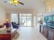 Inviting living room features tile floors, vaulted ceilings, and sliding glass doors offering scenic views at 3518 Terin Ct, Punta Gorda, FL 33950