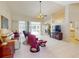 Open living room with tile floors, vaulted ceilings, comfortable seating, and access to outdoor pool area at 3518 Terin Ct, Punta Gorda, FL 33950