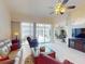 Bright living room with tile floors, ceiling fan, and sliding glass doors leading to the lanai and pool at 3518 Terin Ct, Punta Gorda, FL 33950