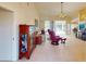 Spacious living room with neutral tile flooring, vaulted ceilings, and access to the outdoor pool area at 3518 Terin Ct, Punta Gorda, FL 33950