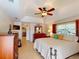 Primary bedroom with tray ceiling, dresser, and adjacent bathroom access at 3518 Terin Ct, Punta Gorda, FL 33950