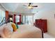 Bright main bedroom boasts a ceiling fan, dresser, sitting area, and sliding door access to the lanai at 3518 Terin Ct, Punta Gorda, FL 33950