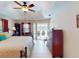 Main bedroom with ceiling fan, tile floor and sliding door to the outside at 3518 Terin Ct, Punta Gorda, FL 33950
