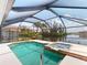 Enjoy this pool and spa with a beautiful view of the waterfront and lush tropical landscaping at 3518 Terin Ct, Punta Gorda, FL 33950
