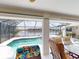 Screened lanai boasts a lovely pool with a scenic view of the canal and comfortable seating area at 3518 Terin Ct, Punta Gorda, FL 33950