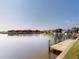 Picturesque waterfront view with a private dock, set against a backdrop of charming red-roofed homes at 3518 Terin Ct, Punta Gorda, FL 33950