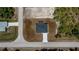 An aerial, overhead view of a well-maintained property and a surrounding unkempt lot at 359 Salisbury St, Port Charlotte, FL 33954