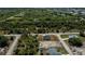 A high angle shot showcasing the property line, the road, and the surrounding lush vegetation at 359 Salisbury St, Port Charlotte, FL 33954