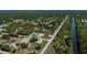 Aerial view of a home in a quiet community surrounded by lush vegetation and canal ways at 359 Salisbury St, Port Charlotte, FL 33954