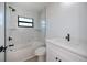 Bright bathroom with a tub, shower, and white vanity at 359 Salisbury St, Port Charlotte, FL 33954