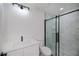 A bathroom featuring a modern shower with glass door, pebbled floor and white marble tiles at 359 Salisbury St, Port Charlotte, FL 33954