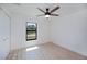 A bright bedroom features a ceiling fan and a window with a view at 359 Salisbury St, Port Charlotte, FL 33954