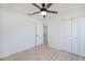 Well-lit bedroom with a ceiling fan, closet, and a view at 359 Salisbury St, Port Charlotte, FL 33954