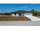 Attractive single-Gathering home with a paved driveway, showcasing its curb appeal and simple landscaping at 359 Salisbury St, Port Charlotte, FL 33954