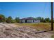 Single-Gathering home with a paved driveway and a side view, set against a natural backdrop at 359 Salisbury St, Port Charlotte, FL 33954