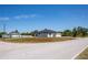 Landscaped single-Gathering home featuring a paved driveway and curb appeal in a peaceful neighborhood setting at 359 Salisbury St, Port Charlotte, FL 33954