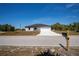 Charming single-Gathering home with a well-manicured lawn, a paved driveway, and a mailbox in the front yard at 359 Salisbury St, Port Charlotte, FL 33954