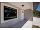 Inviting front entrance with a secure white door and a modern window, complemented by a stylish outdoor light at 359 Salisbury St, Port Charlotte, FL 33954