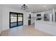 Bright kitchen features stainless steel appliances, white cabinets and a sliding glass door to the backyard at 359 Salisbury St, Port Charlotte, FL 33954